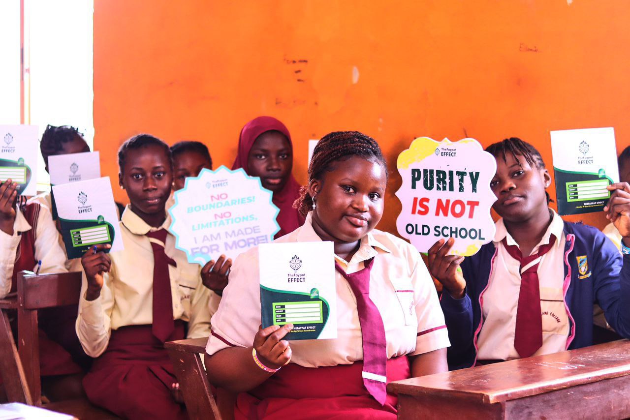 Girls holding purity campaign signs on Day of the Girl Child