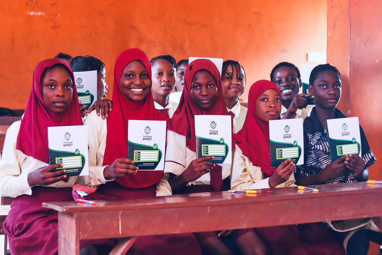 Students receiving Faypat Effect materials during a school visit